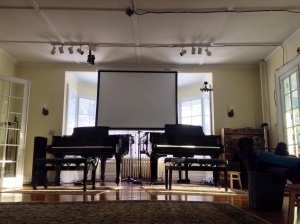 Living room pianos with overhead screen for music. Photo by Todd Pinter
